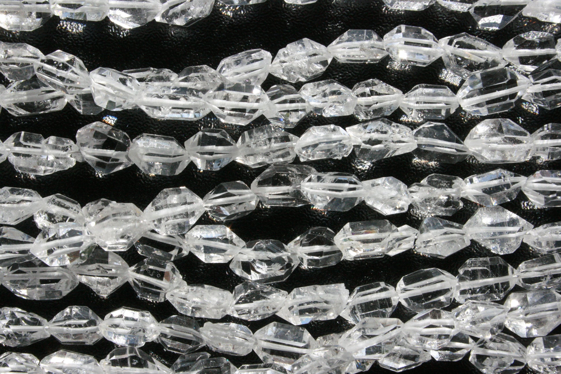 Close‑up van bergkristal kristalvorm kralen met heldere lichtreflectie